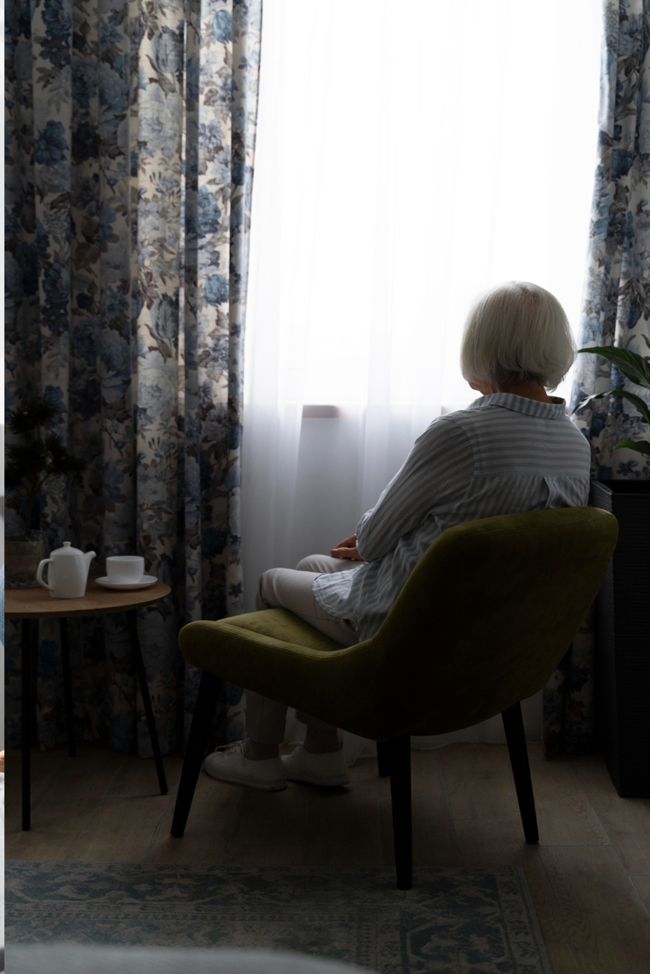 Elderly Women sitting by the window