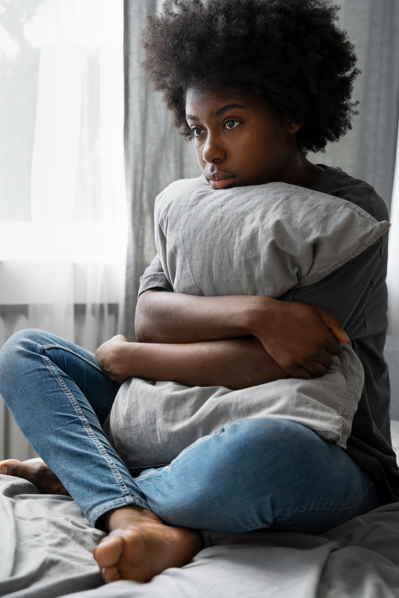 black woman holding a pillow